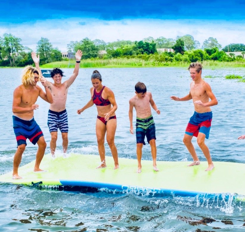 Friends jumping on a floating foam mat
