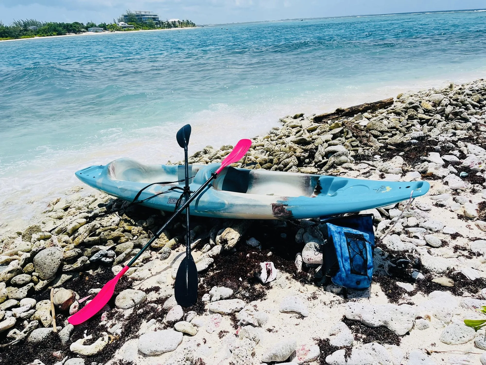 Kayak and paddles resting on the rocks