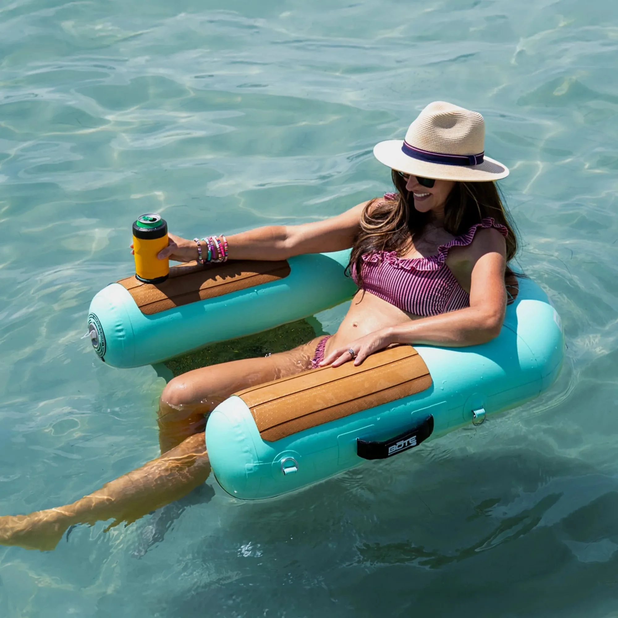 Woman relaxing in an inflatable sling chair on the water