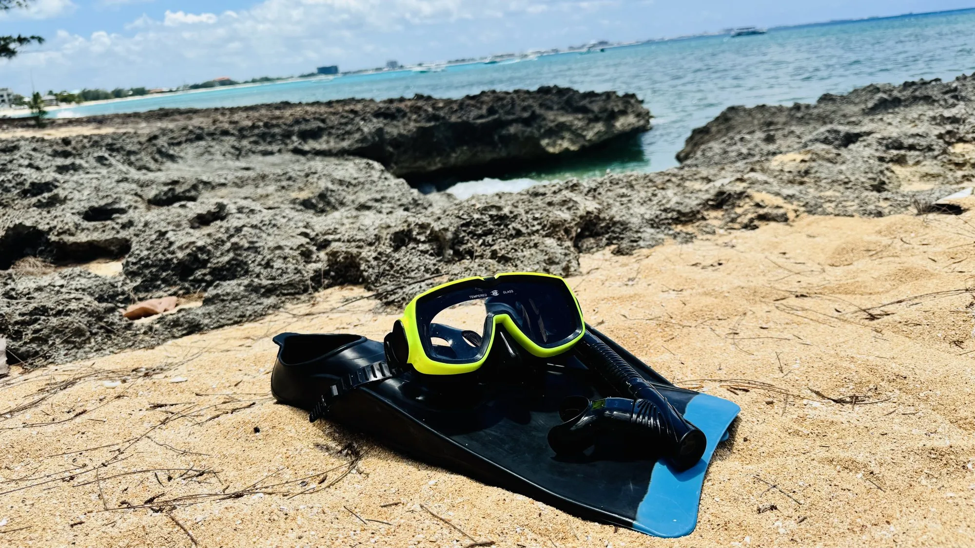 Mask, snorkel and fins on the rocks by the sea