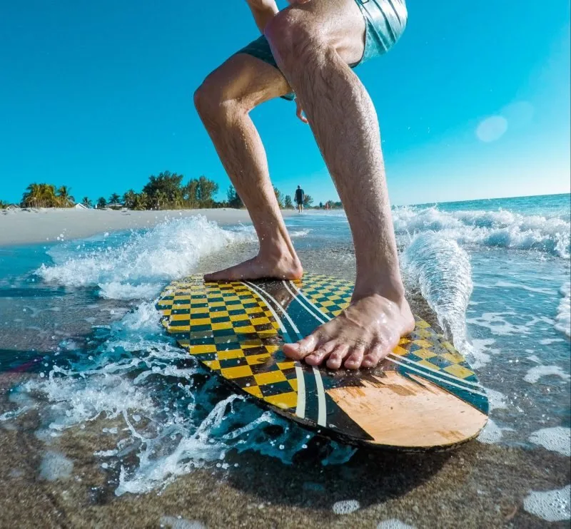 Skim board gliding over a breaking wave