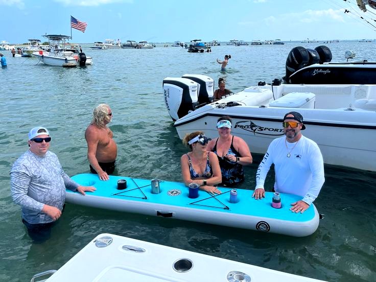 Friends gathered around a floating sandbar table
