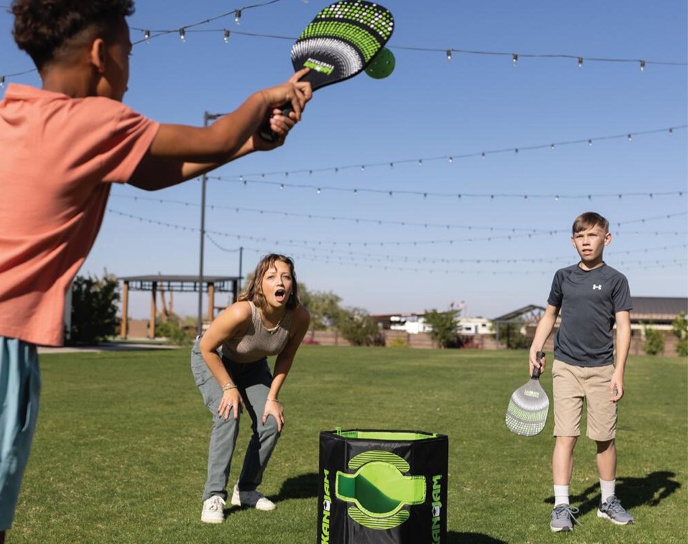 Family playing Pickleball Jam on the grass