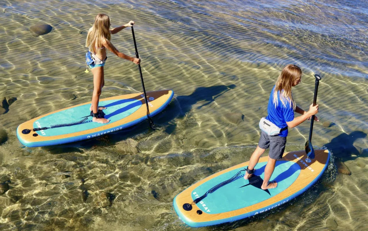 Two children on inflatable kid's paddleboards
