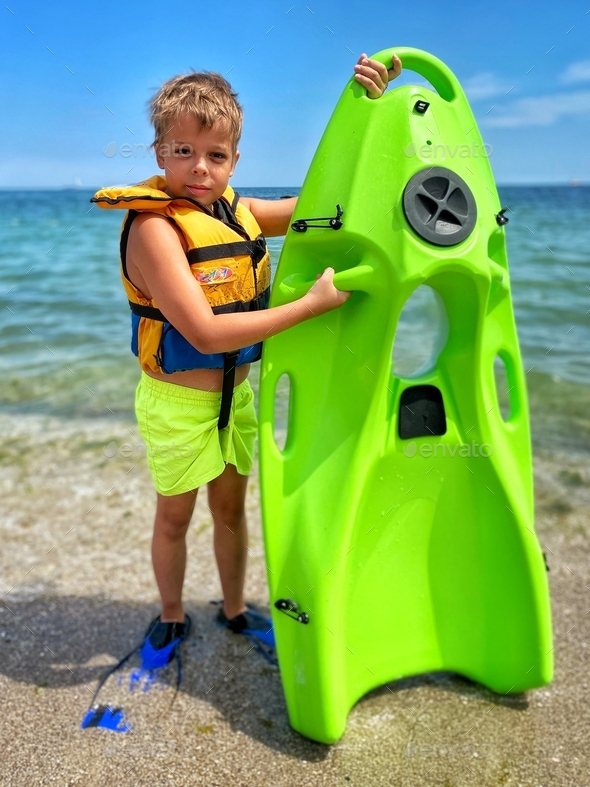 Boy holding a green Reef Board